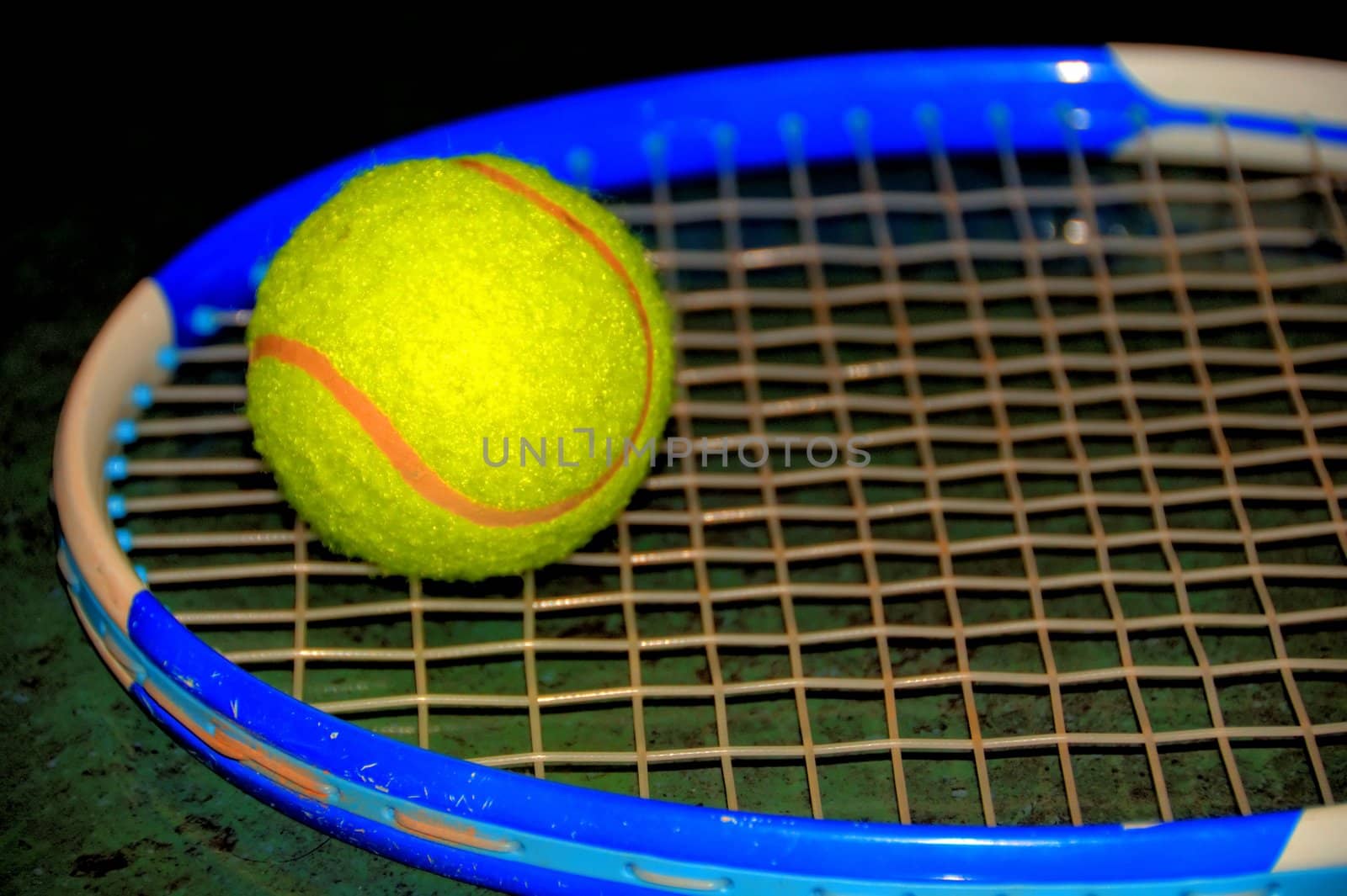 tennis ball and racket on green background