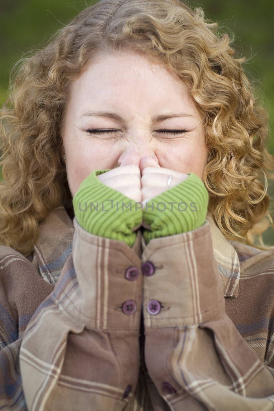 Pretty Young Woman Sneezing Outdoors.