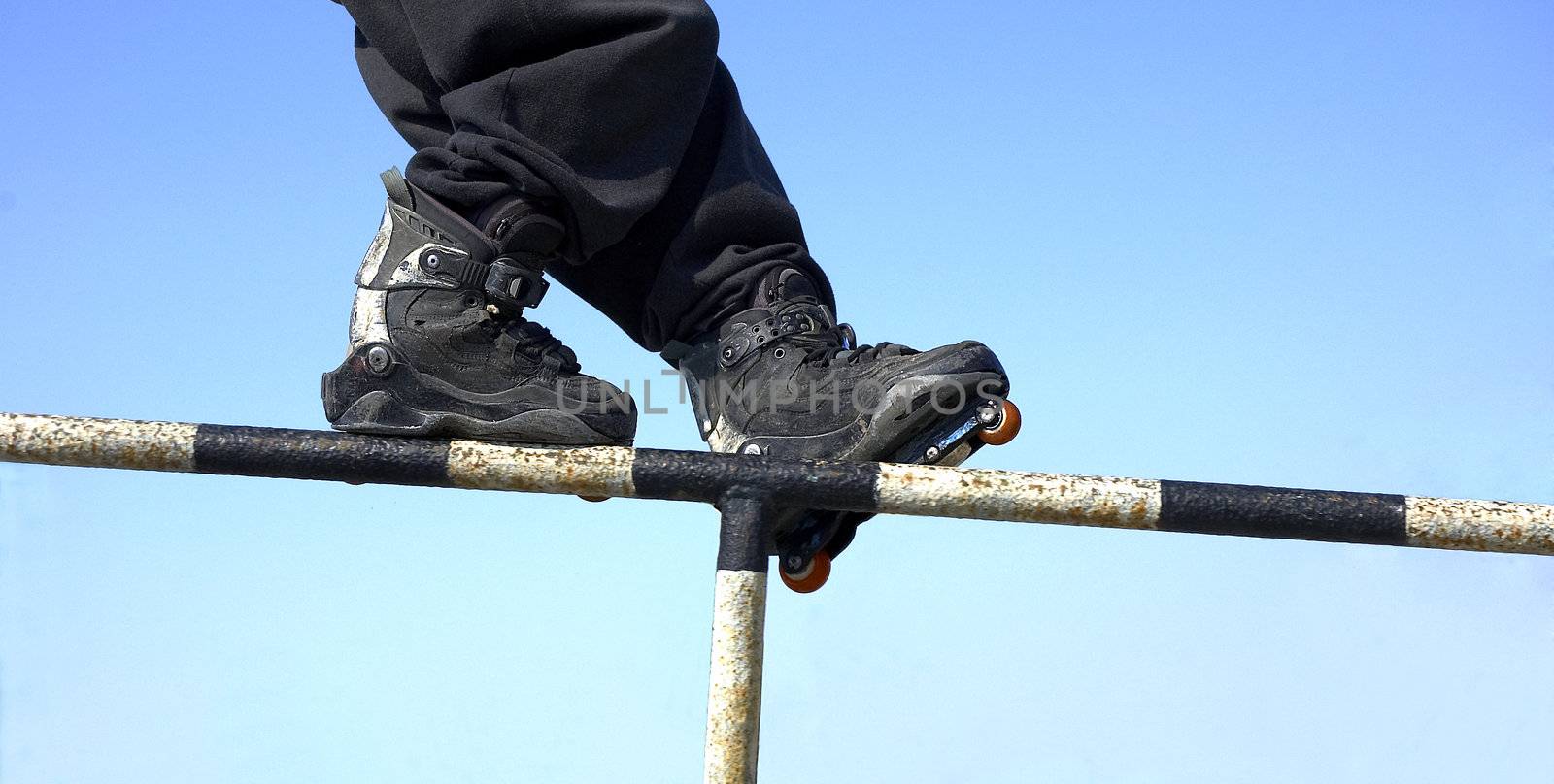 Close-up of roller skates in a motion on blue background