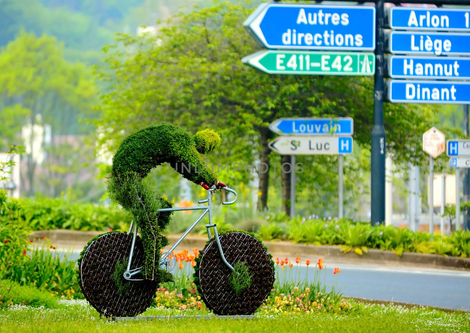 Figure of bicyclist made of the green grass