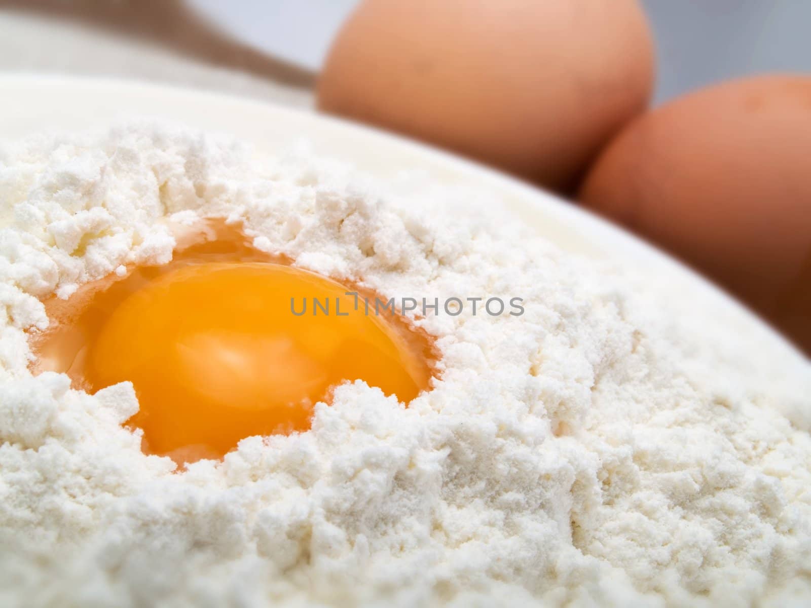 Egg and flour in a white plate