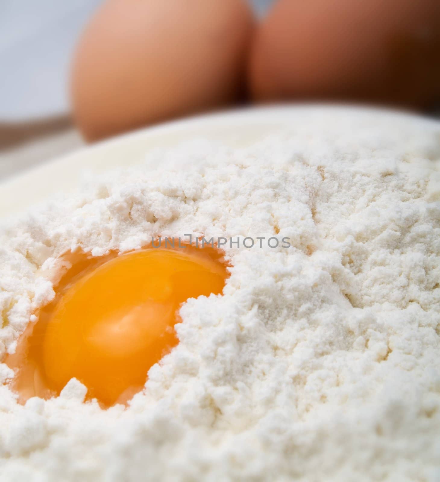 Egg and flour in a white plate