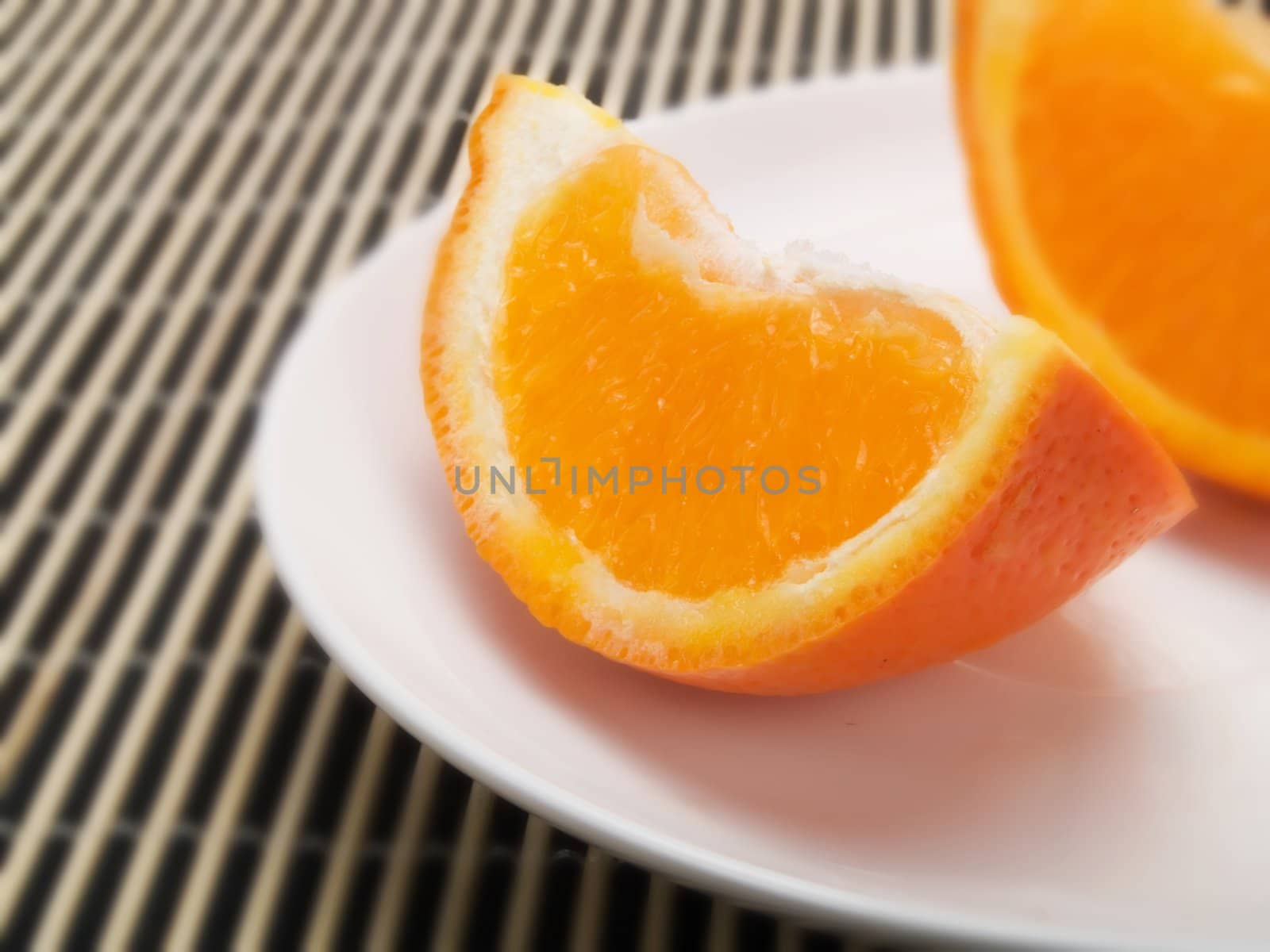 Orange slice on  a white plate