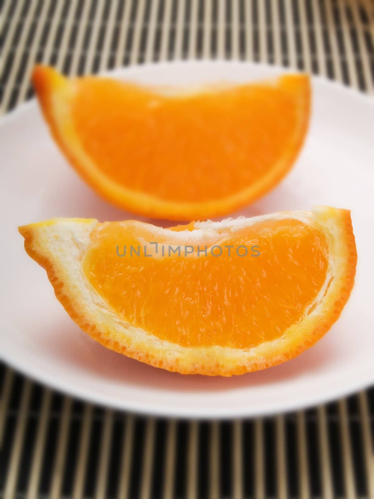 Orange slice on  a white plate