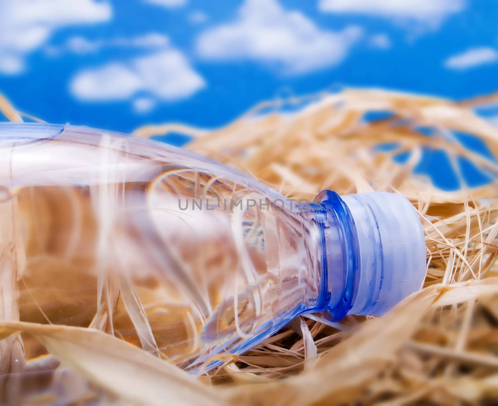 Bottle of mineral water over a blue sky