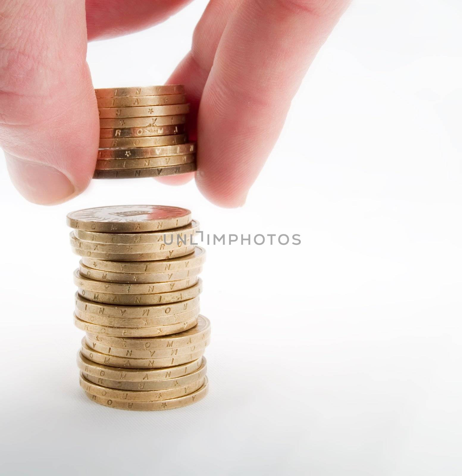 Pile of coins and hand on a white background