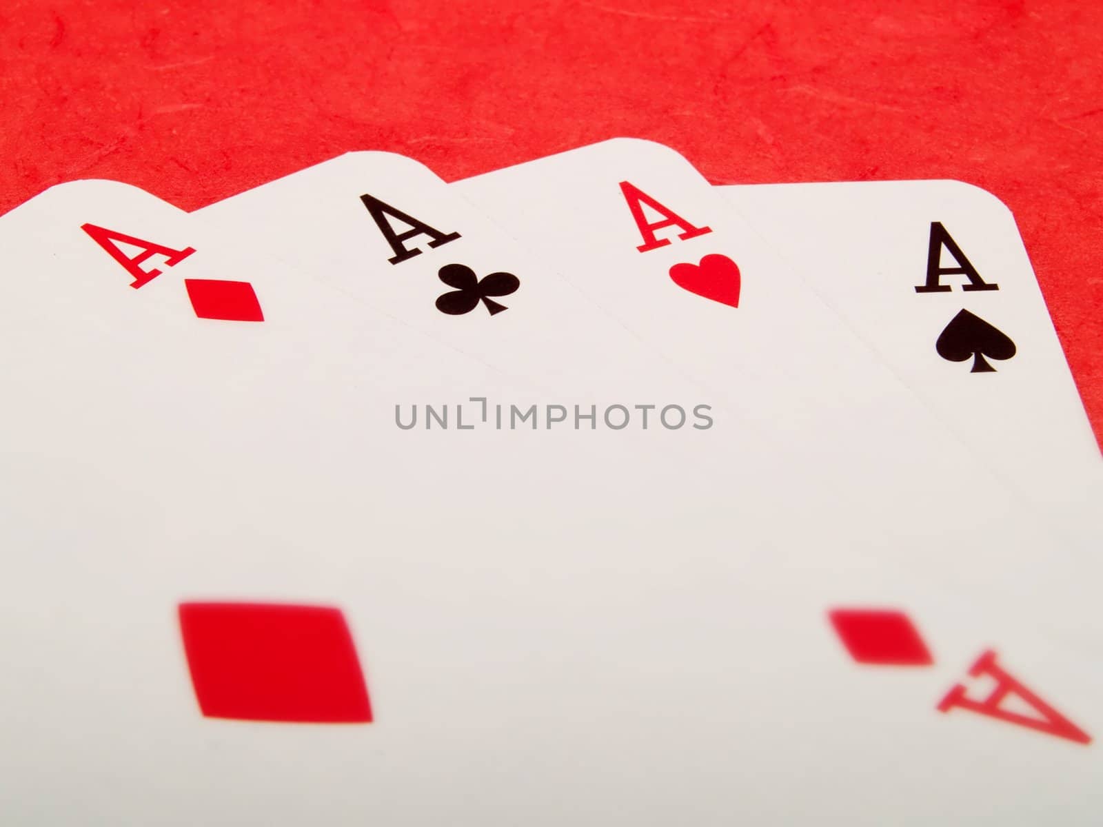 Four aces cards on a red background