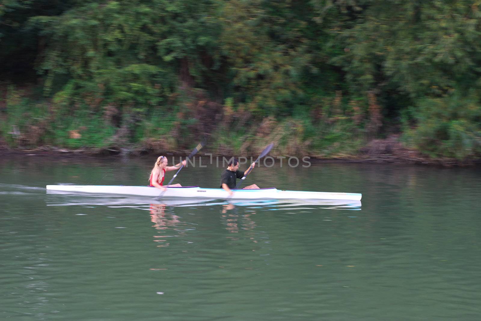 couple rowing over the river Thames, Oxford, UK, motion blur