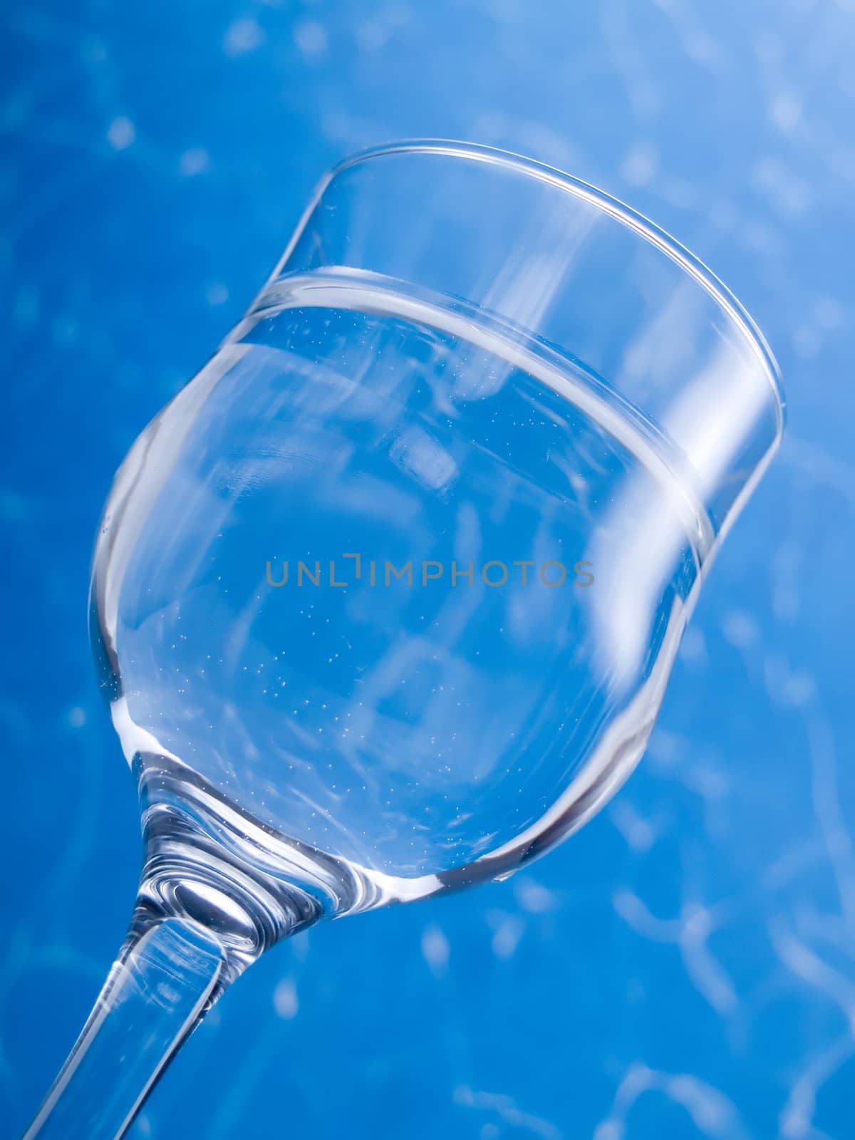 Glass of water on a blue background