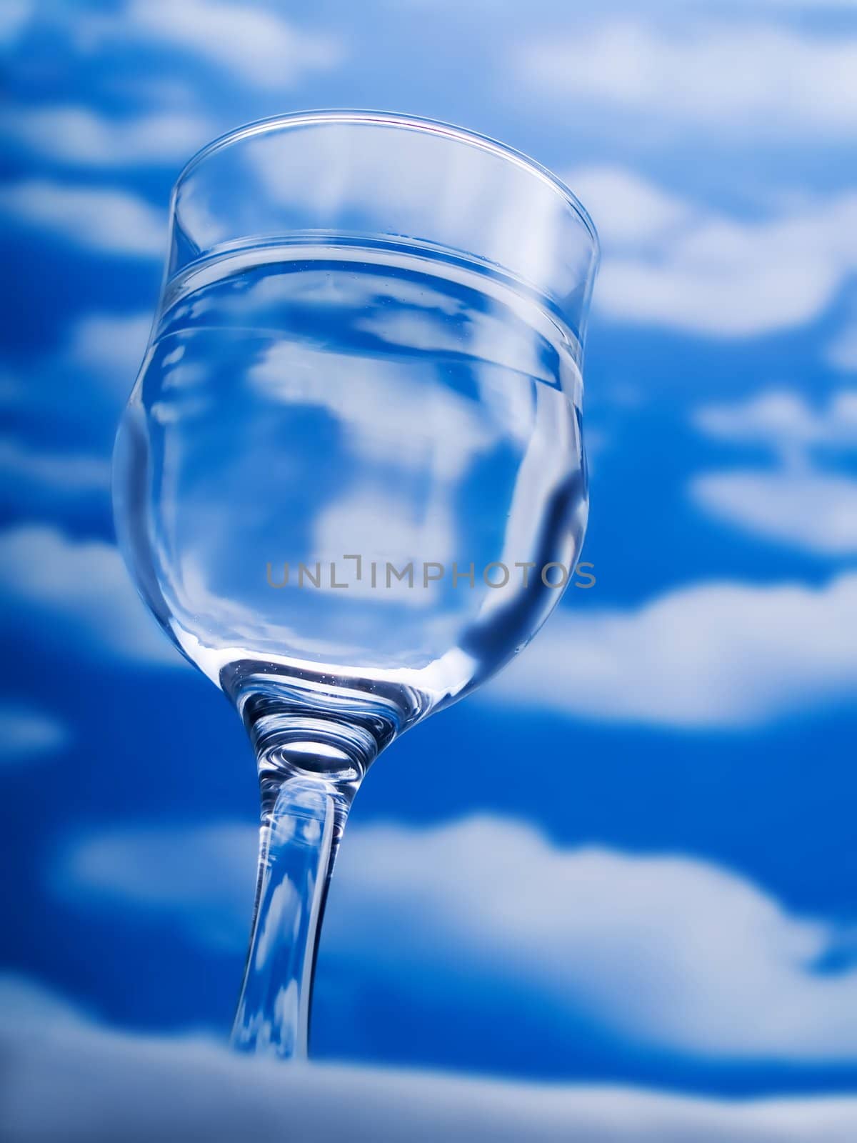 Glass of water over a blue sky