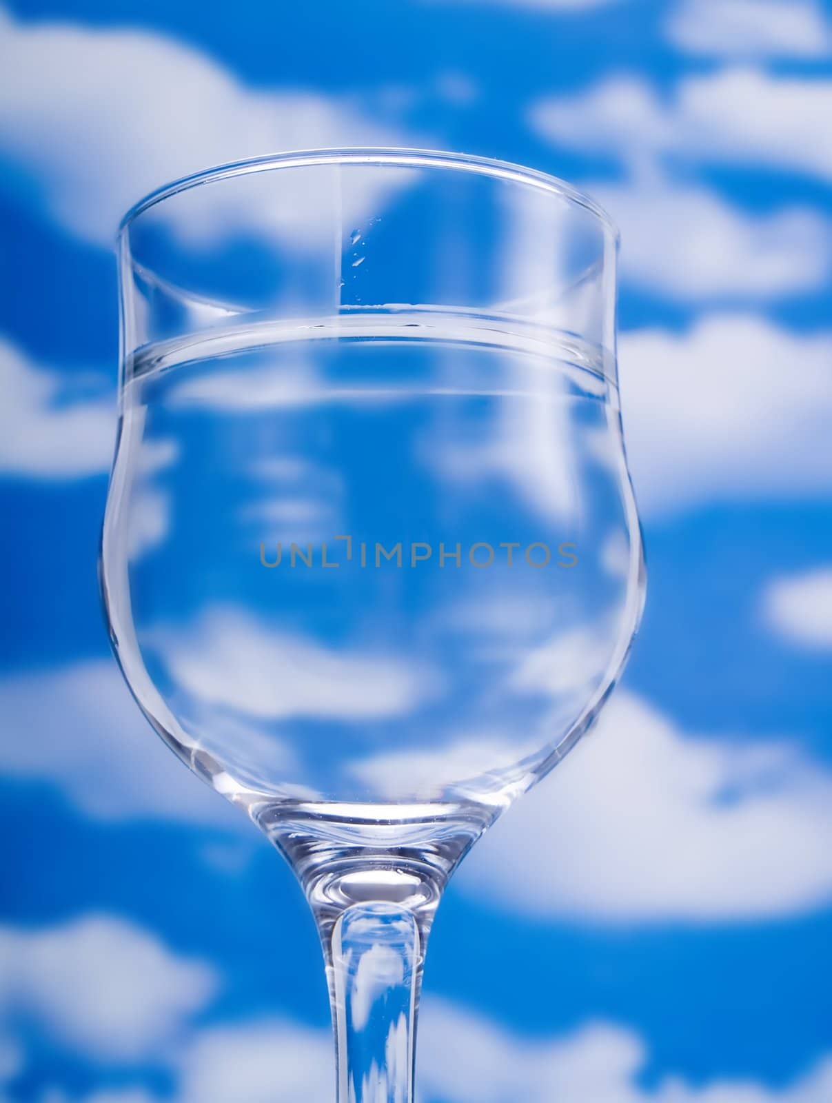 Glass of water over a blue sky