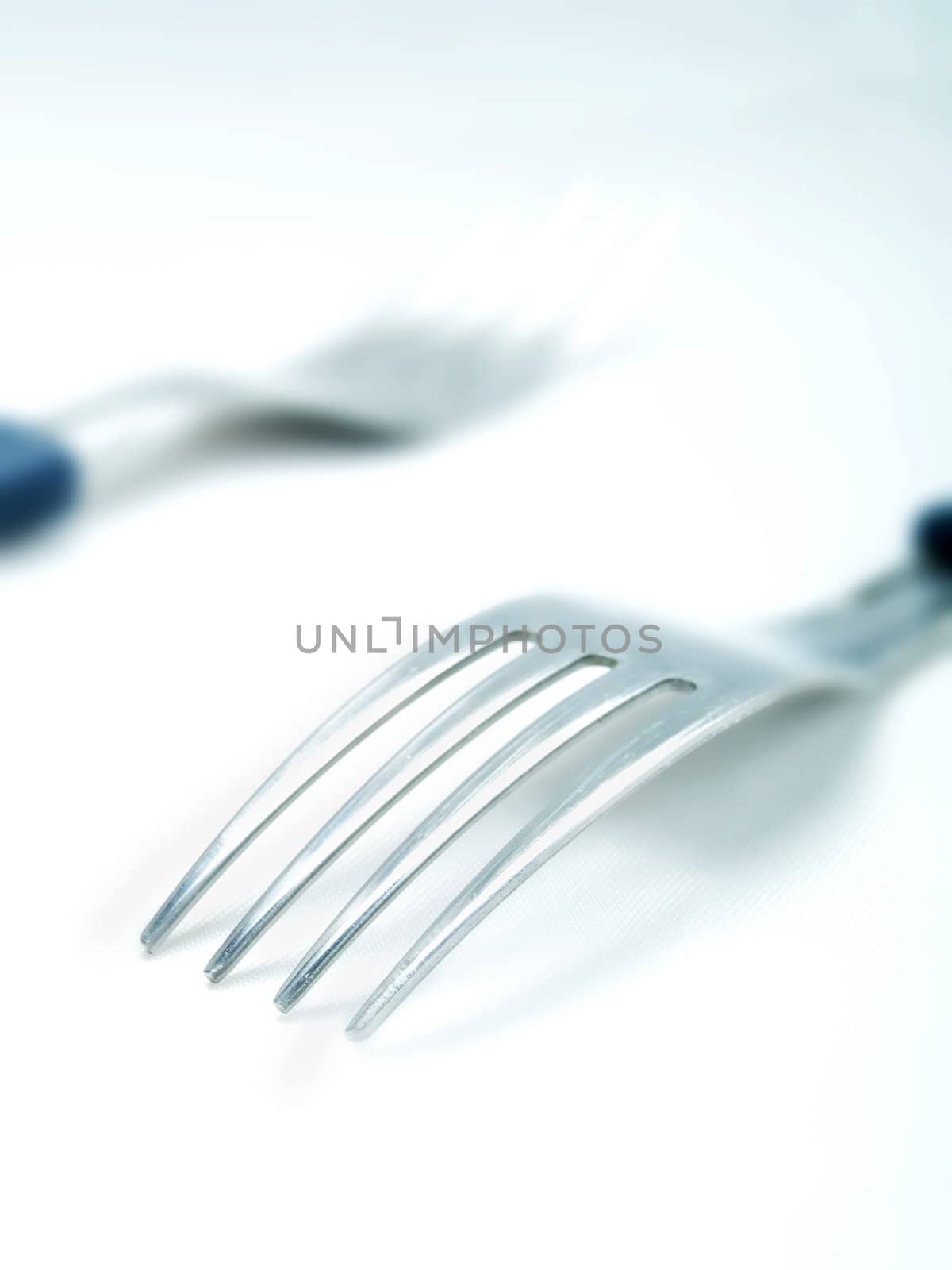 Two forks on a white background