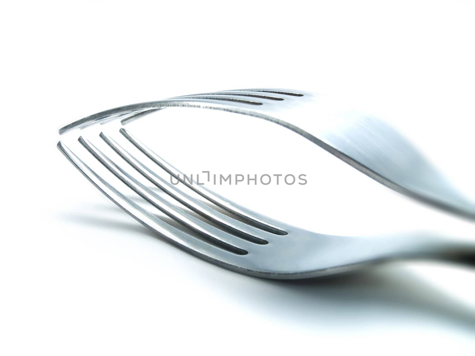 Two forks on a white background