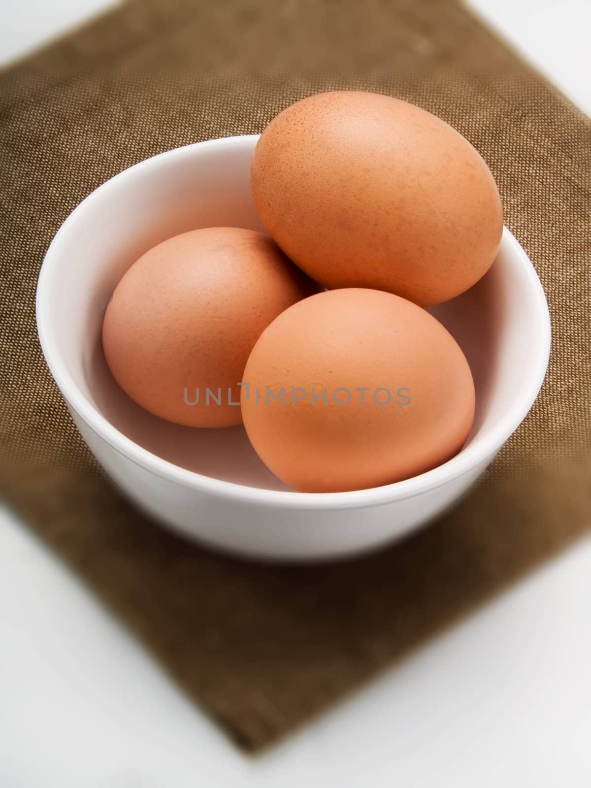 Three eggs in a white bowl