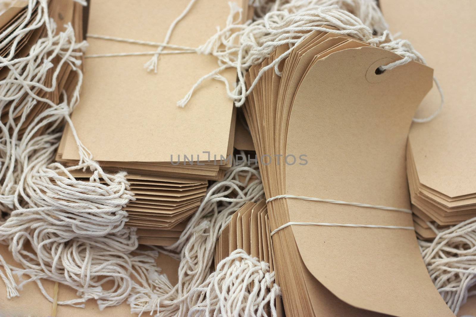 box with beige labels with strings