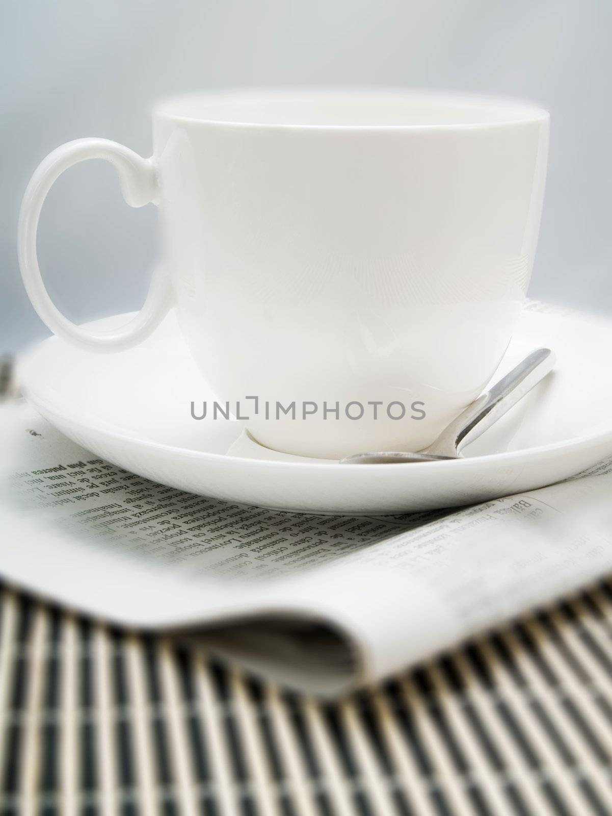 Coffee cup and newspaper