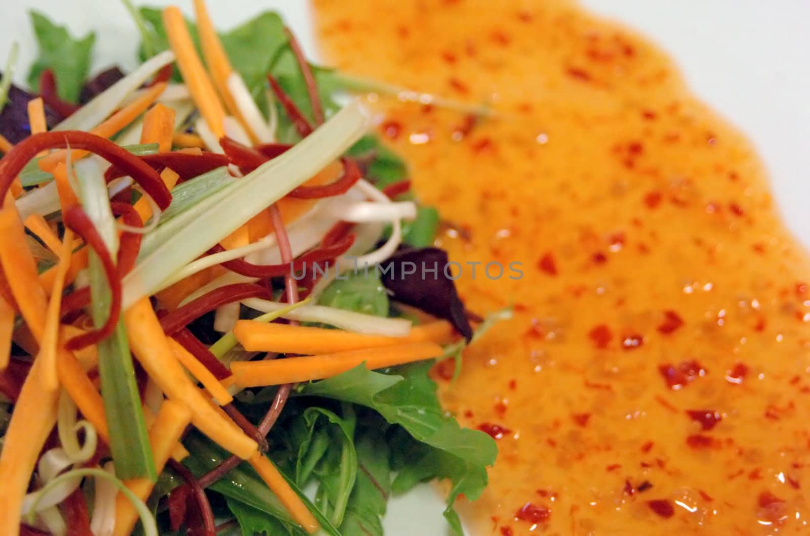 close up of asian salad with sweet chili drizzle