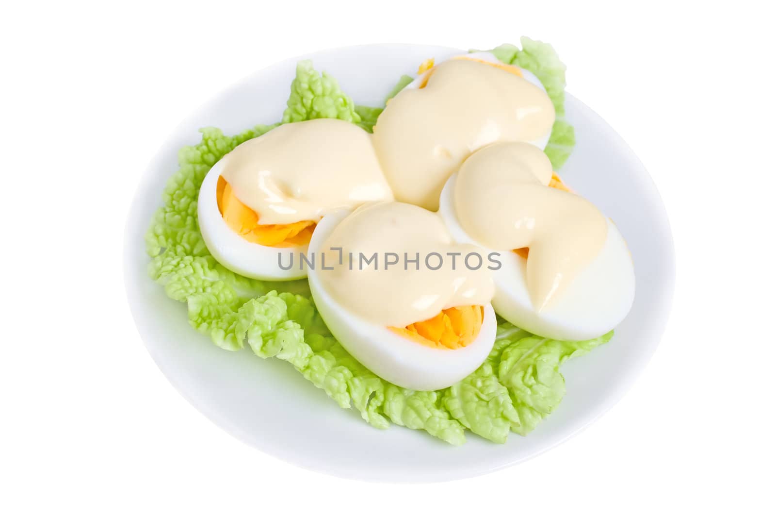 Eggs with mayonnaise on green lettuce leaf