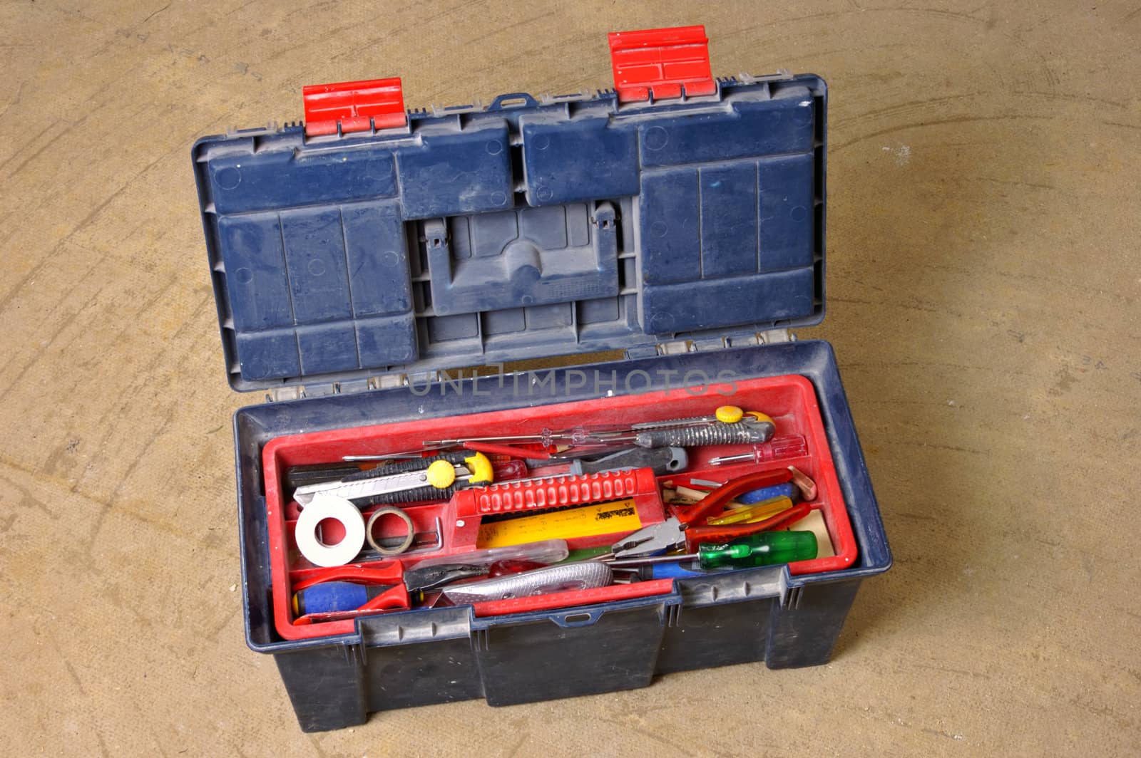 A workman's toolbox on a stripped floor, during construction work.