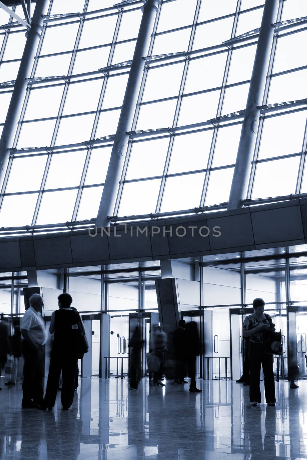 People in a modern architectural interior. Tint in blue