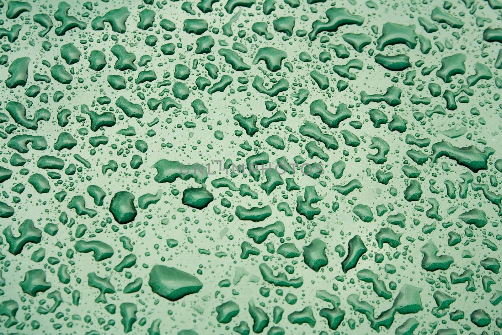 Water Droplets on a Green Steel Surface. Close-up