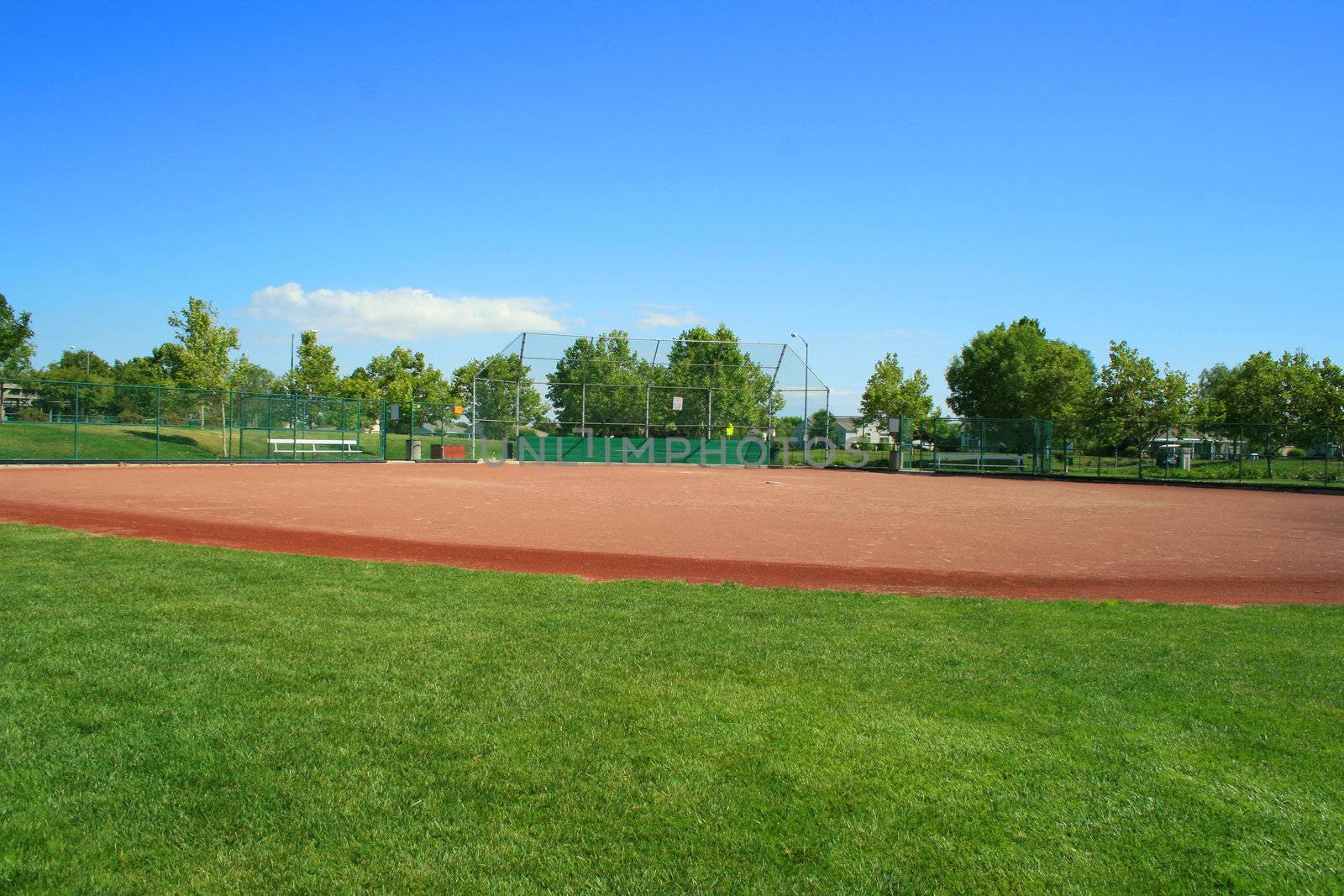 Empty baseball field on a sunny day.
