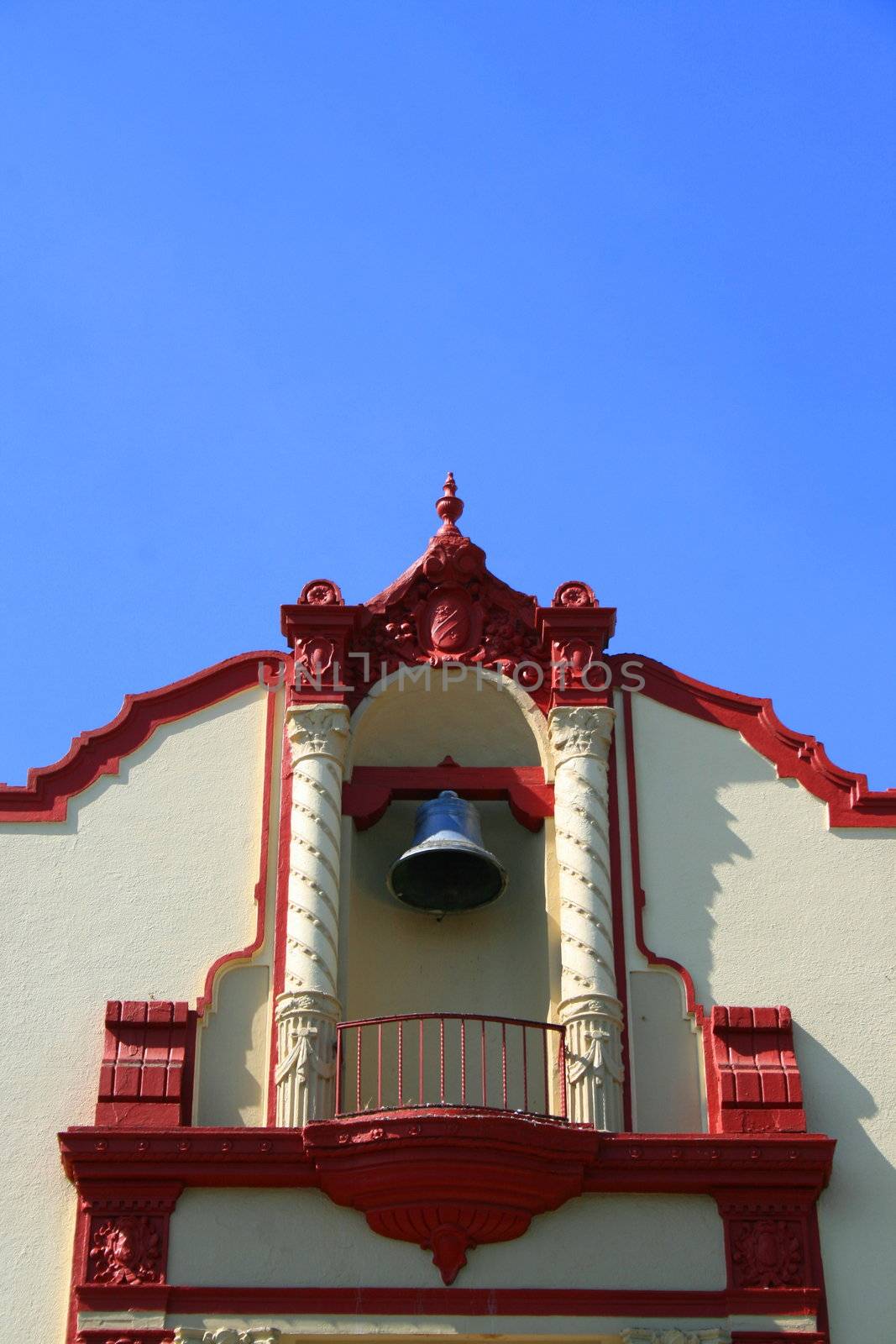 Tall classic style church in a city.
