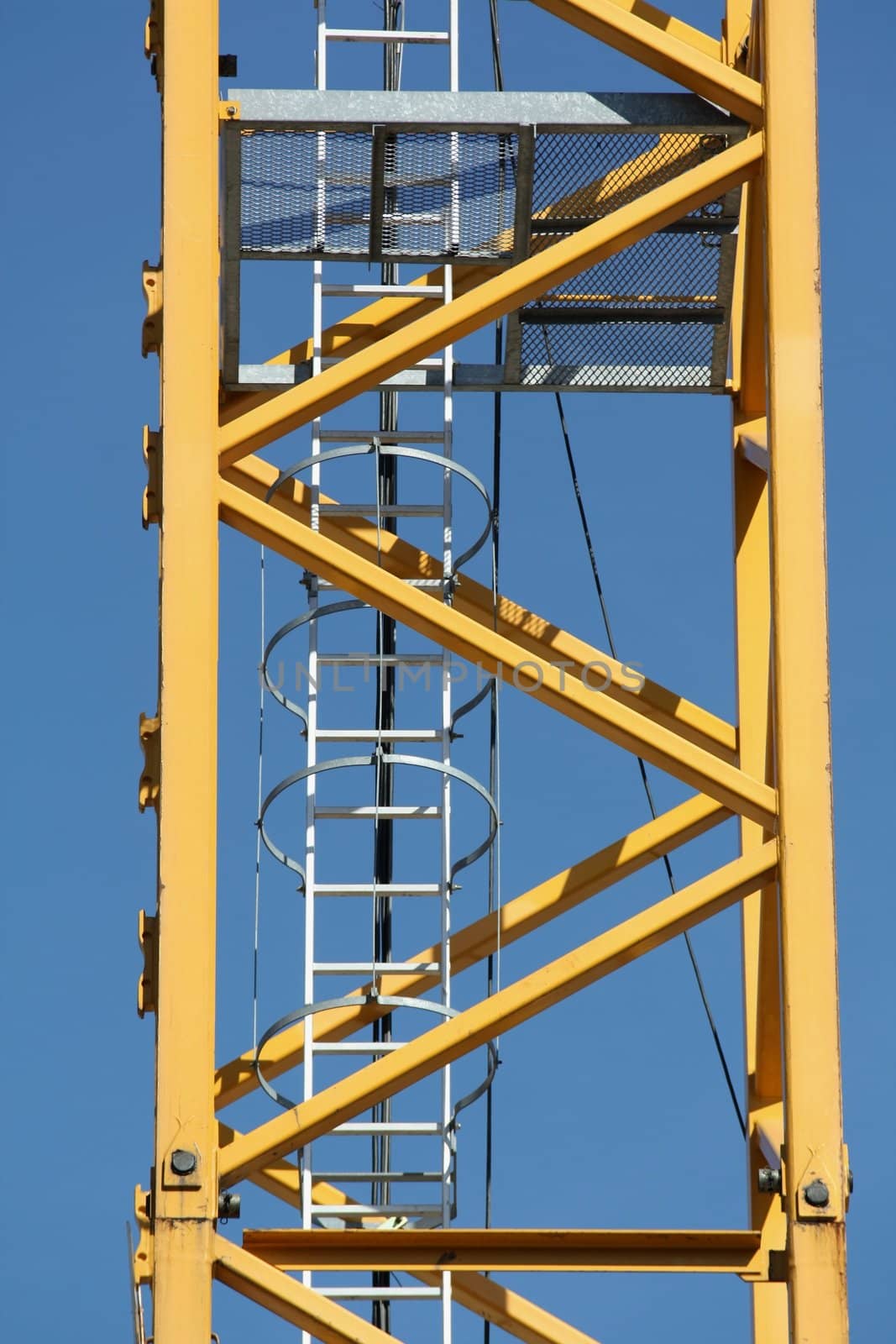 Ladder on a crane on a blue sky background