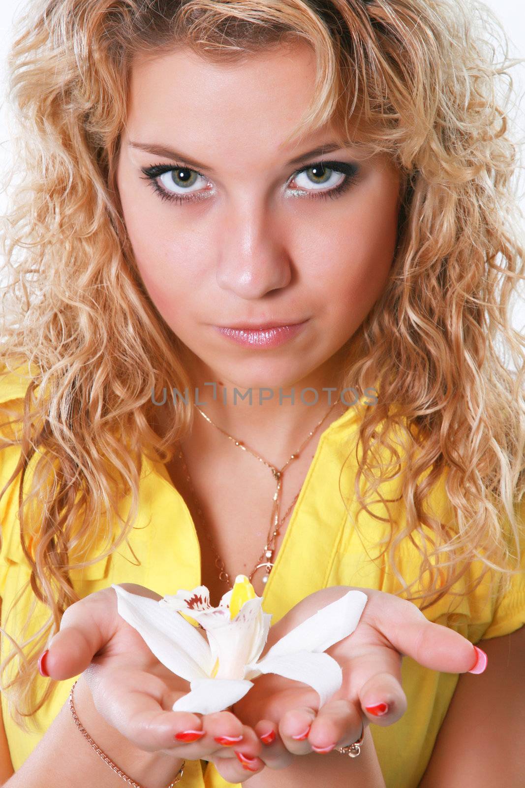  The girl in yellow clothes with a flower in hands