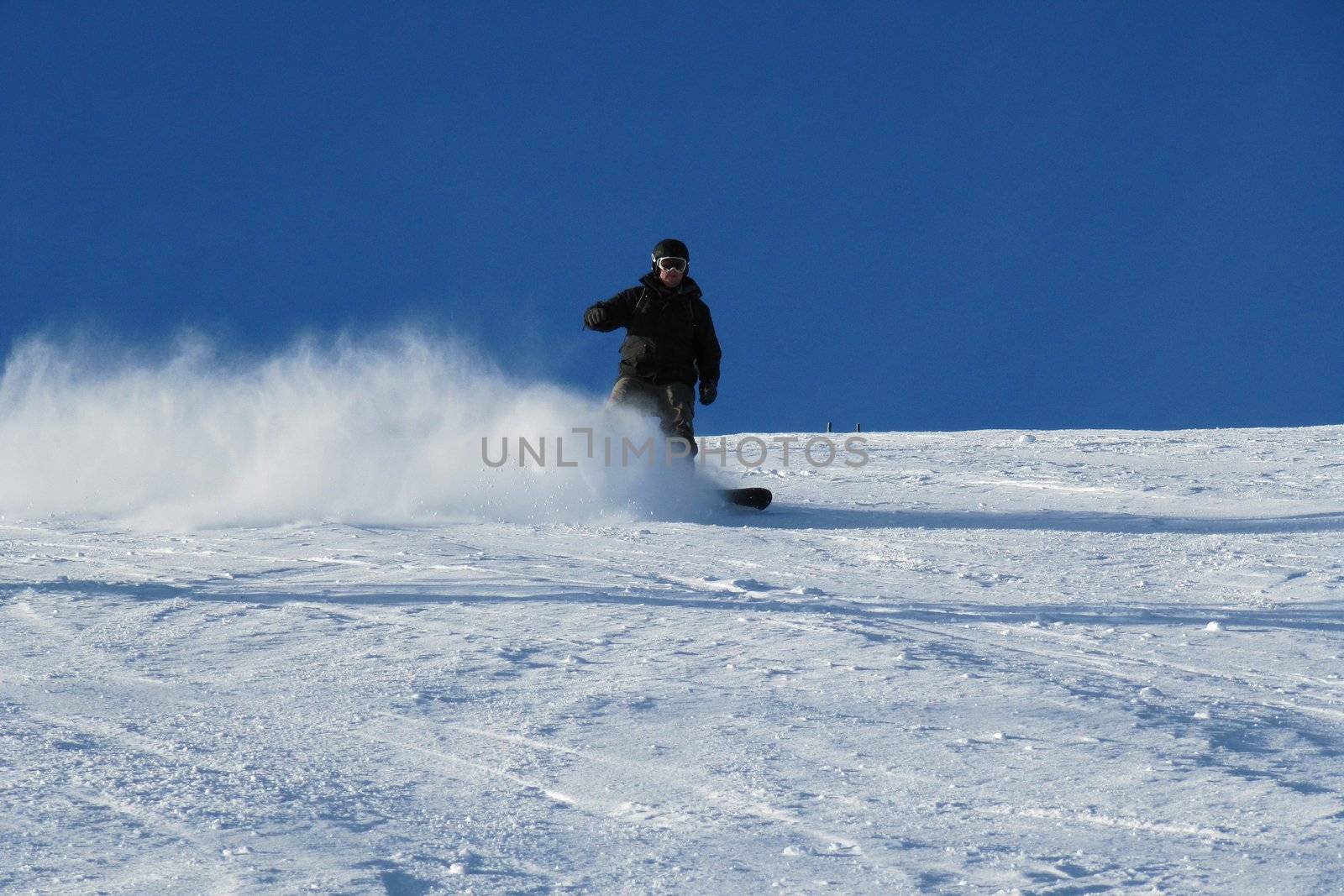 Snowboarding under a bluebird sky by chrisga