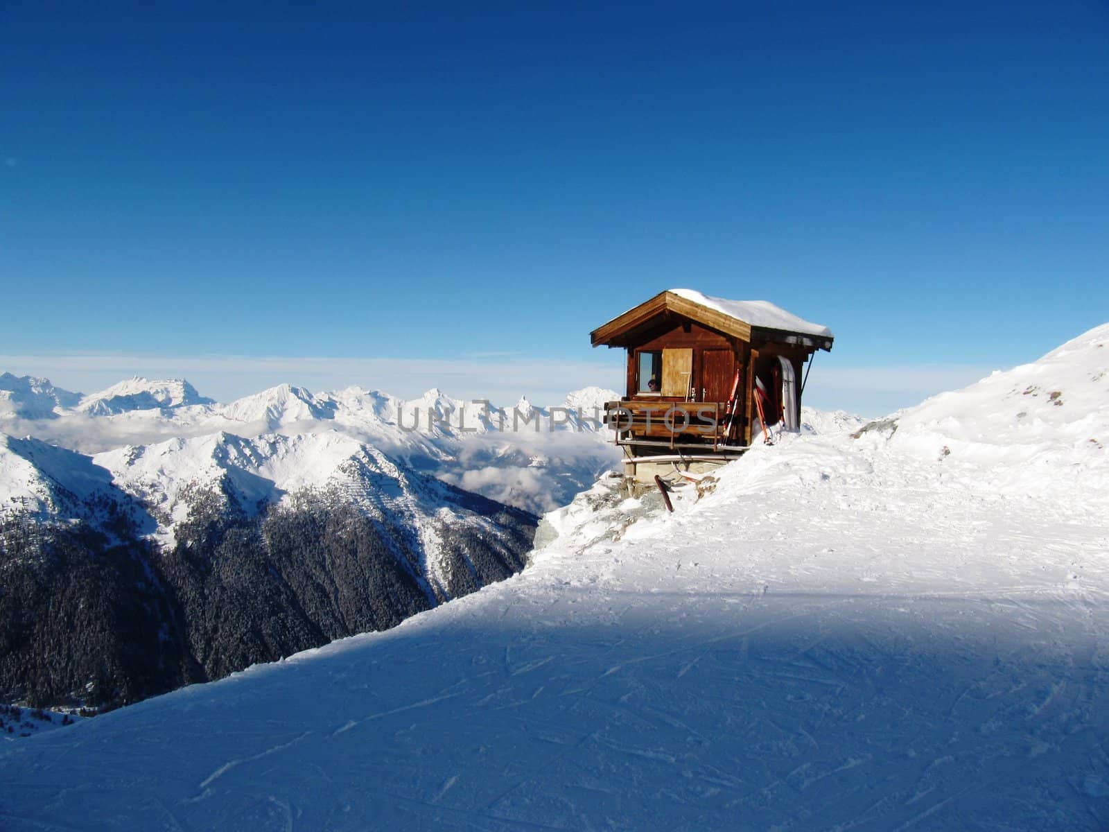 Mountain top cabin/hut perched precariously on the side of a mountain