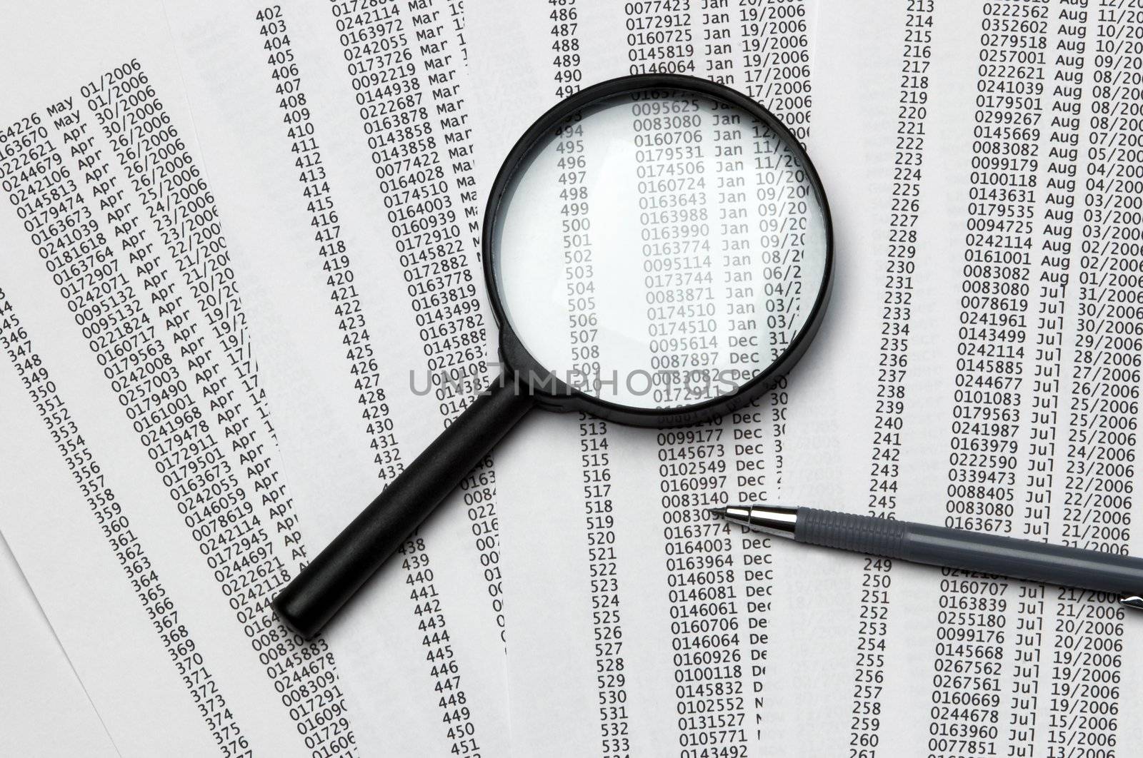 magnifier,papers and pen(focus point on the center of the photo)