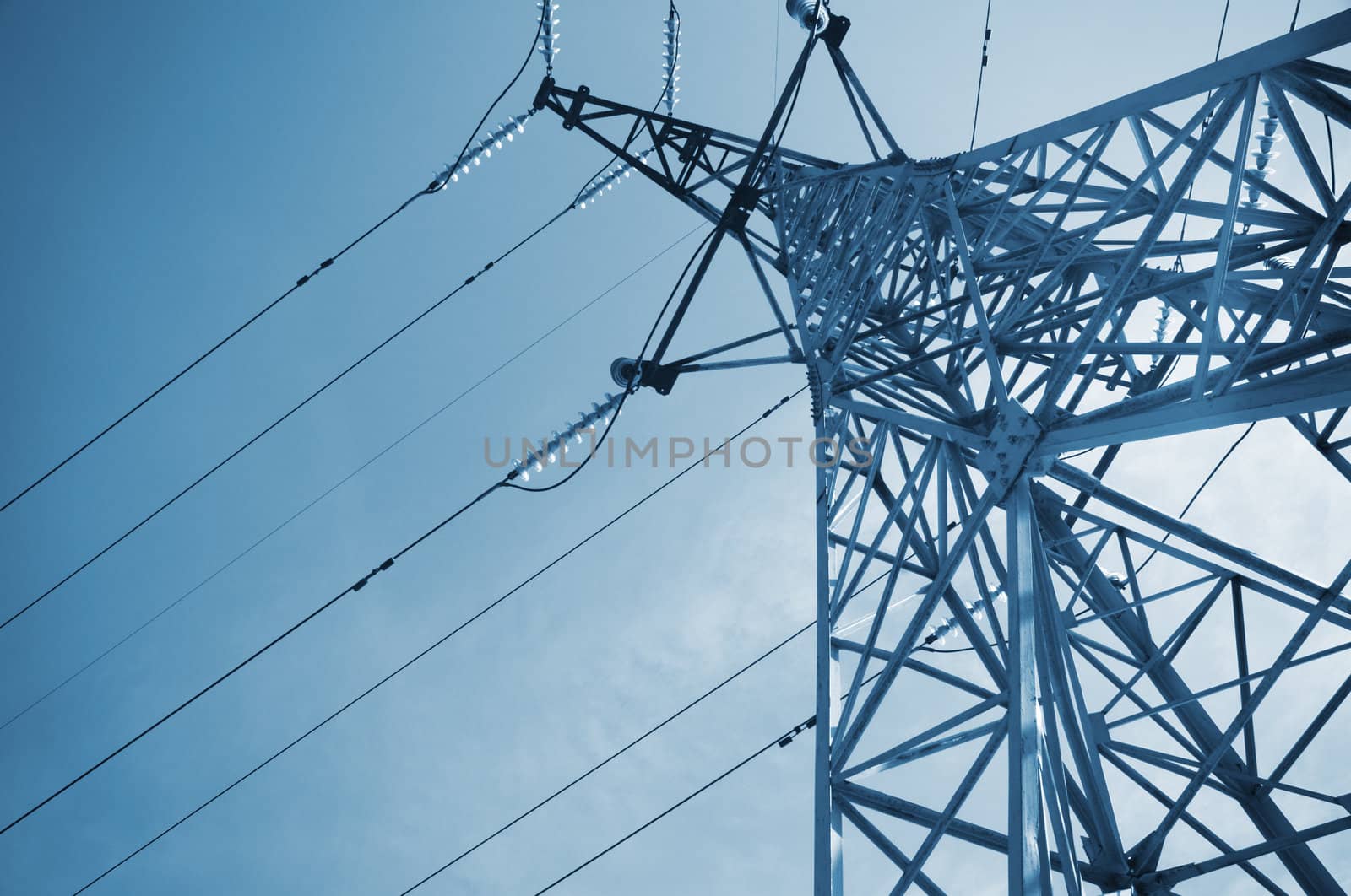 high-voltage line on the sky background,special blue toned photo f/x with vignetting,selective focus