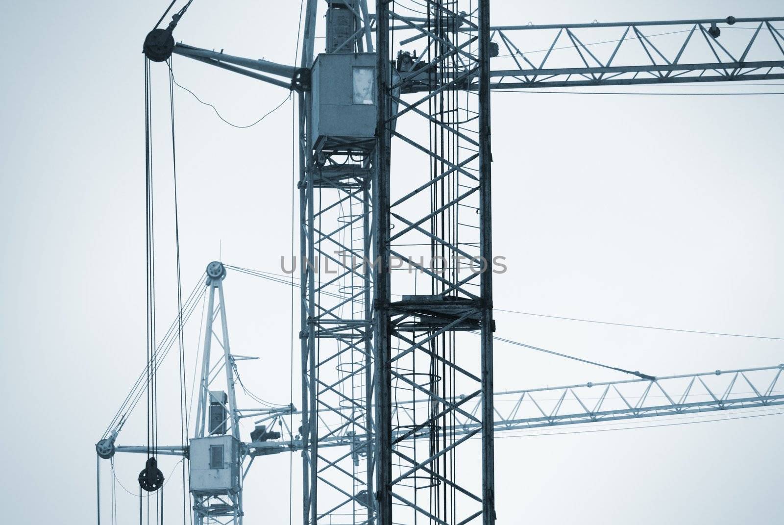 special blue photo toned f/x with dark vignetting,focus on the nearest part of crane