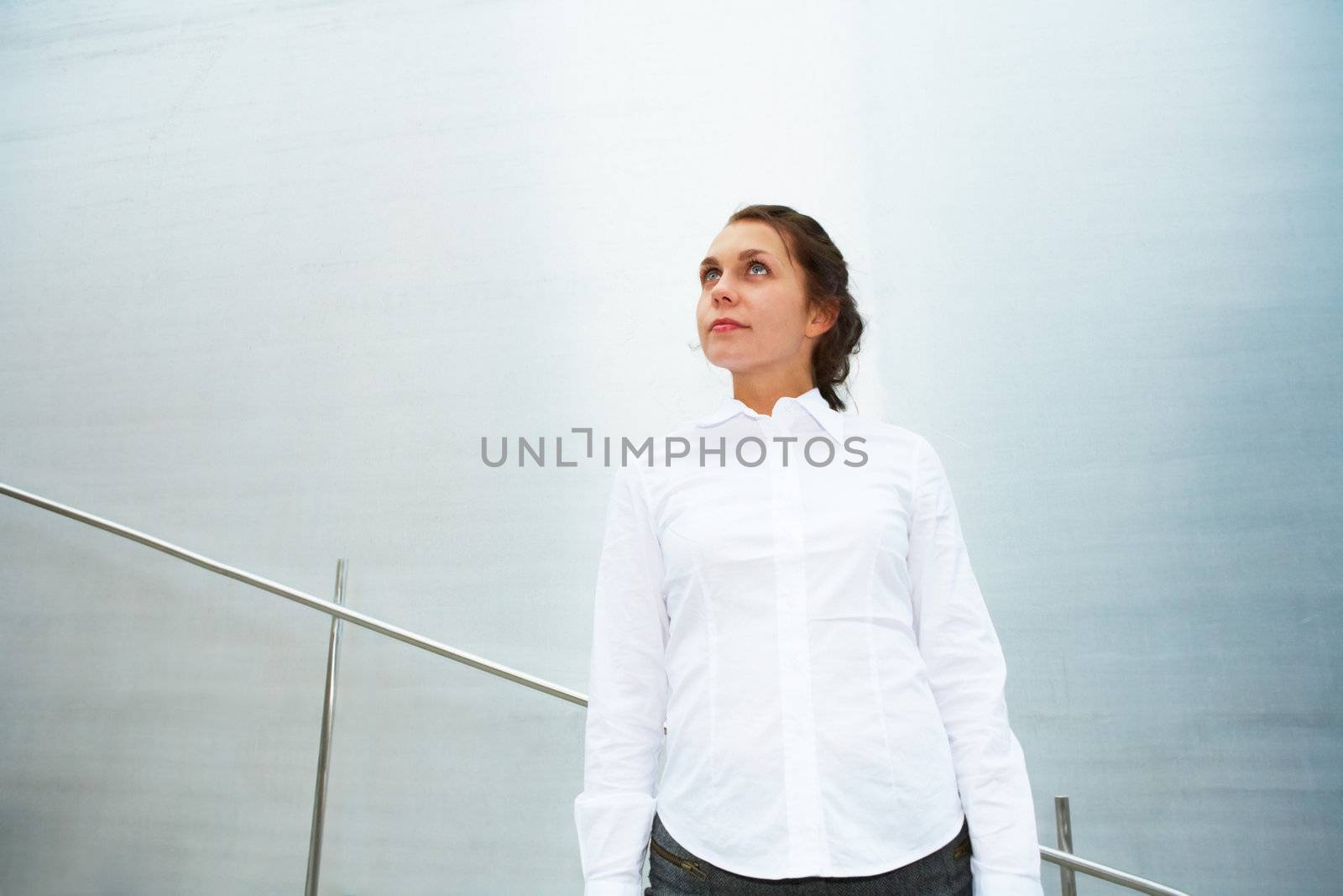 Young woman contemplating outside building