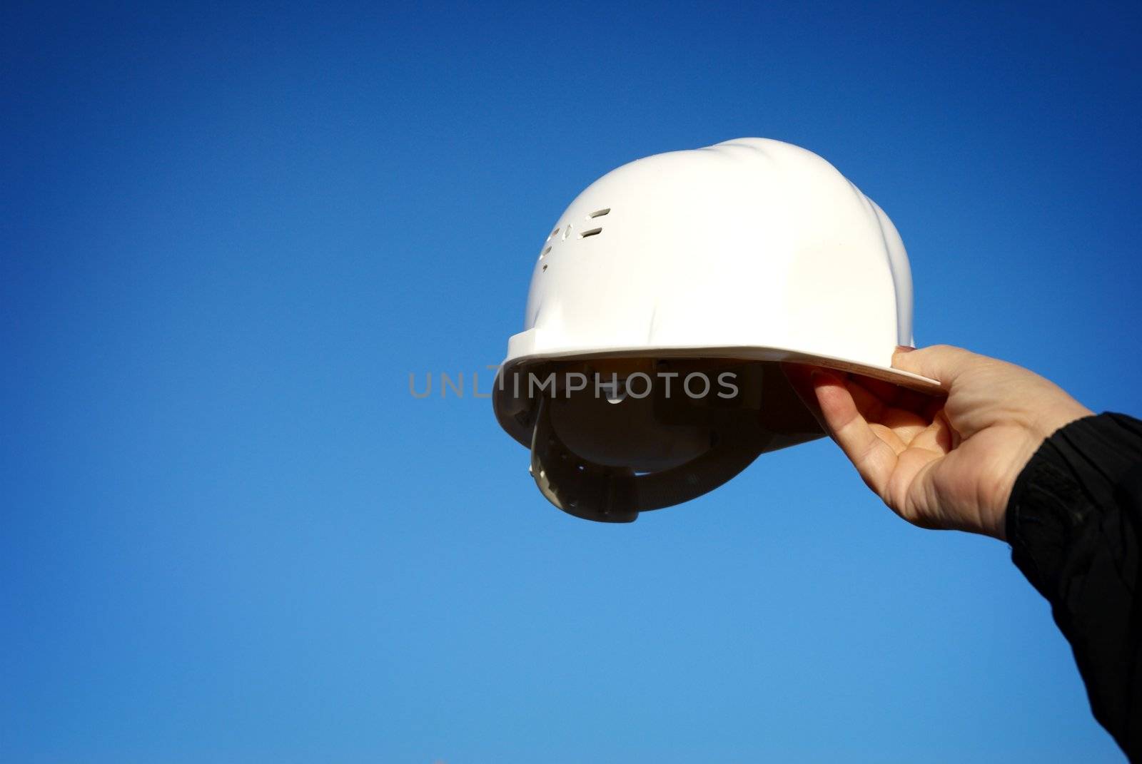 white hard-hat, special blue vignetting focus on the hand