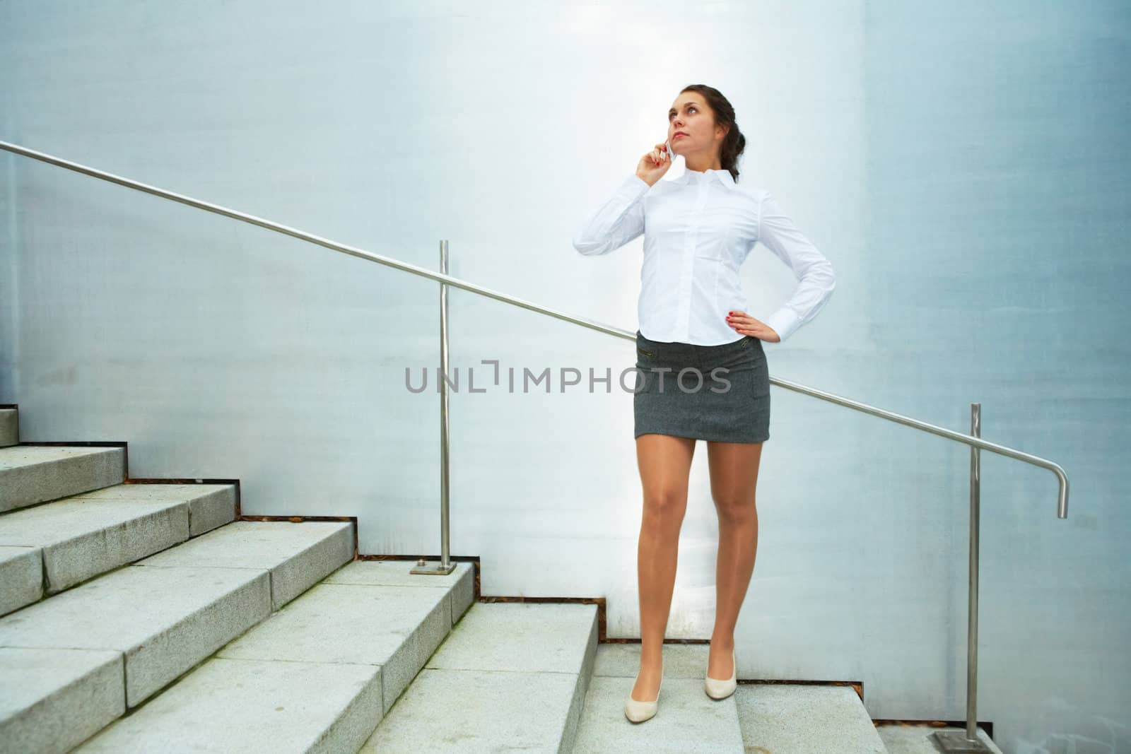 Young woman using mobile phone on stairs