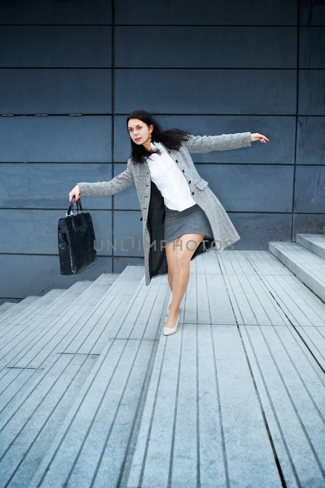 Young woman balancing on staircase