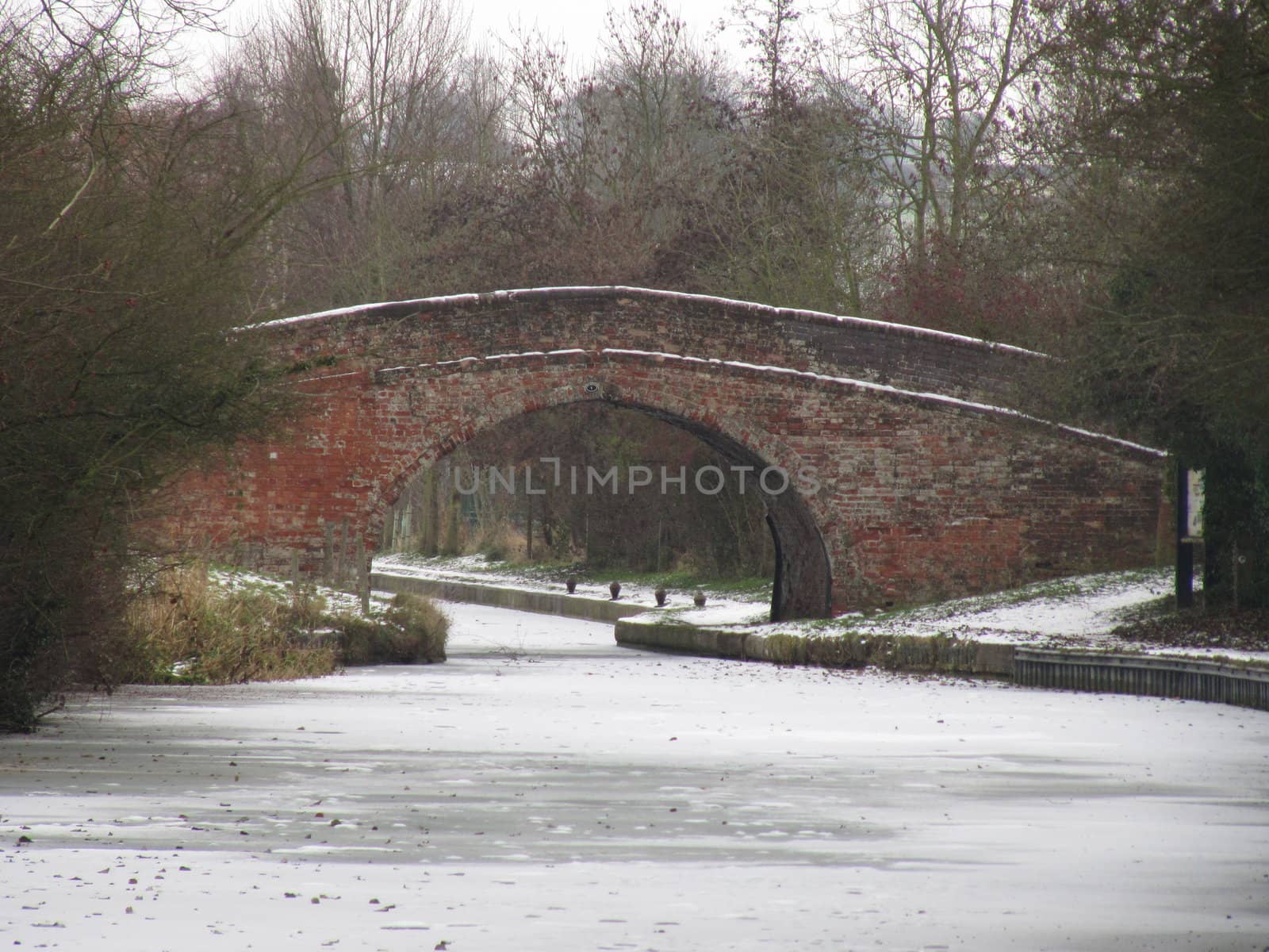 Bridge over a frozen canal by chrisga