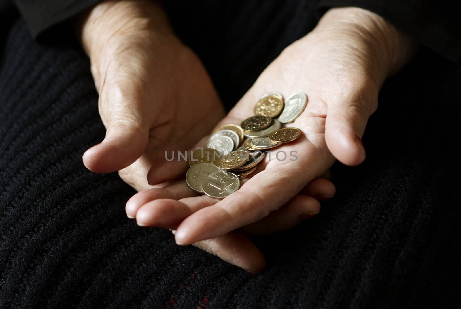 old hand with coins, selective focus