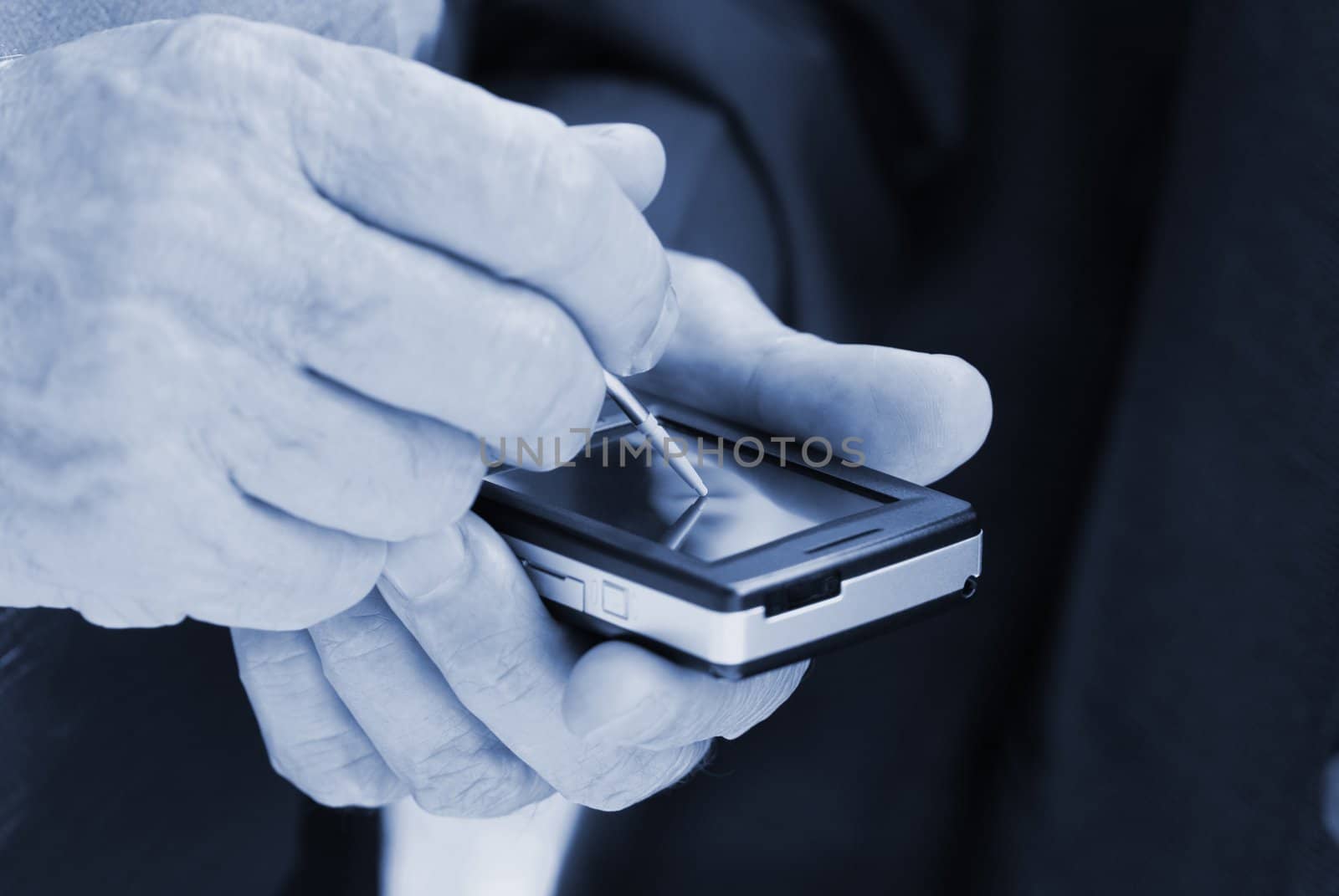 hands with palmtop ( focus point on stylus, special toned)
