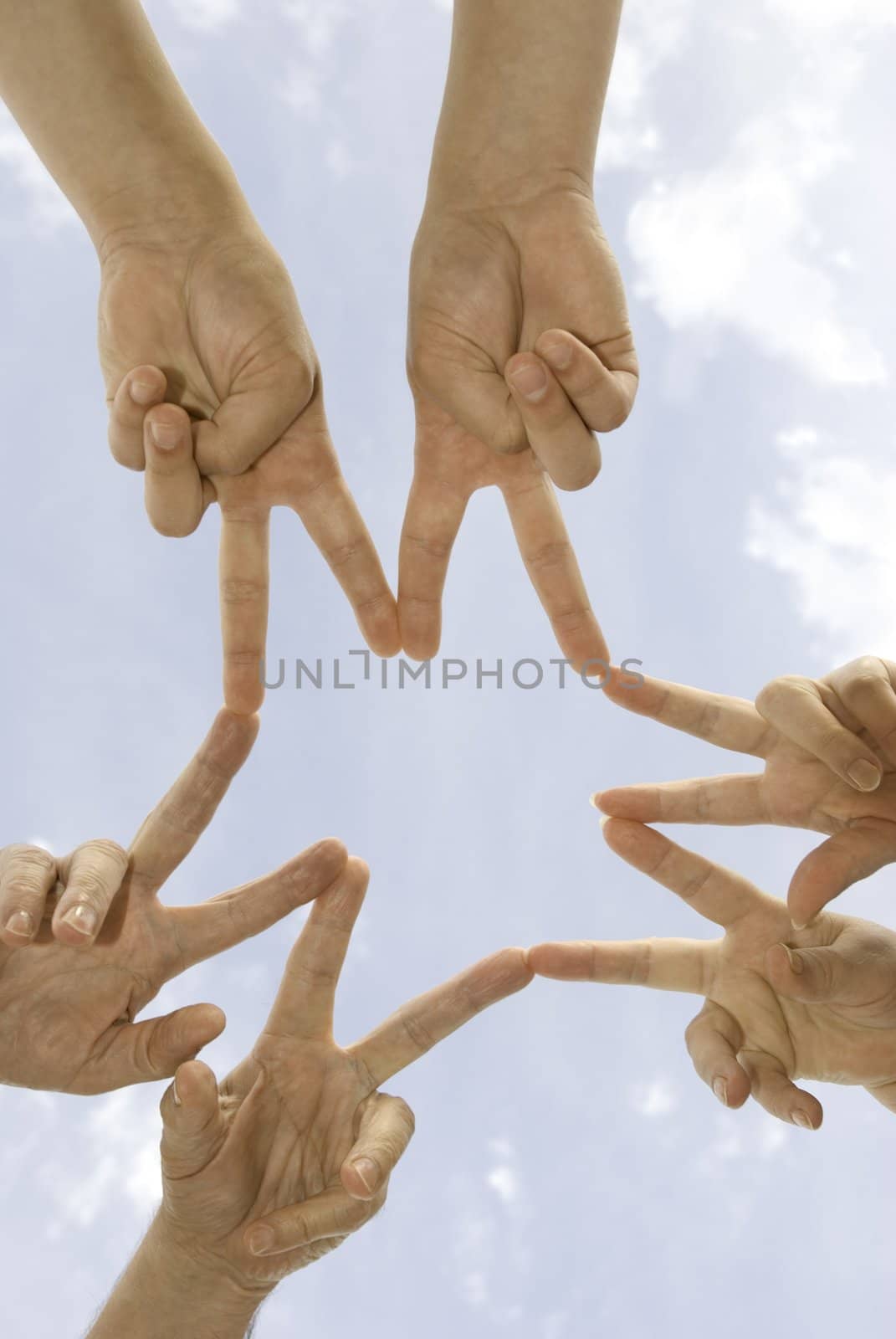 fingers of team on sky background(special toned , focus on hands(selective))