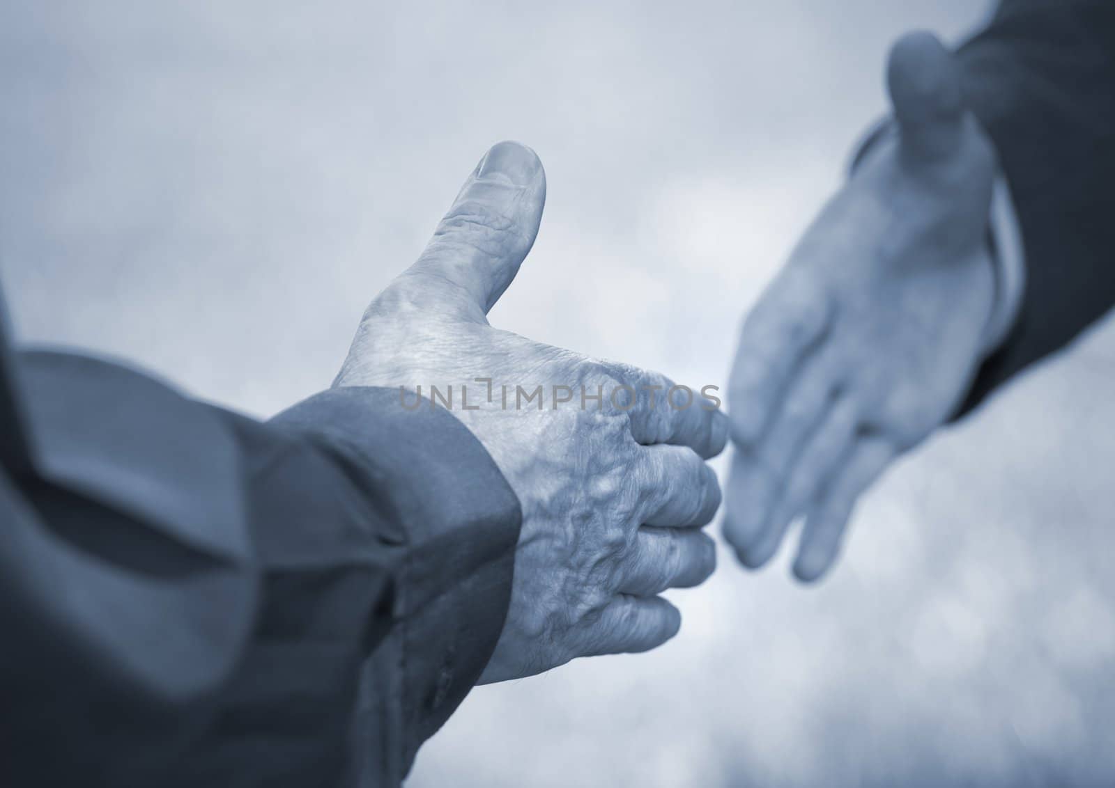 hands of men (special toned photo f/x, selective focus on nearest hand)