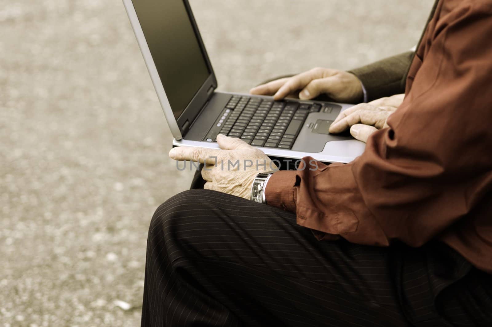 two businessmen with computer outside