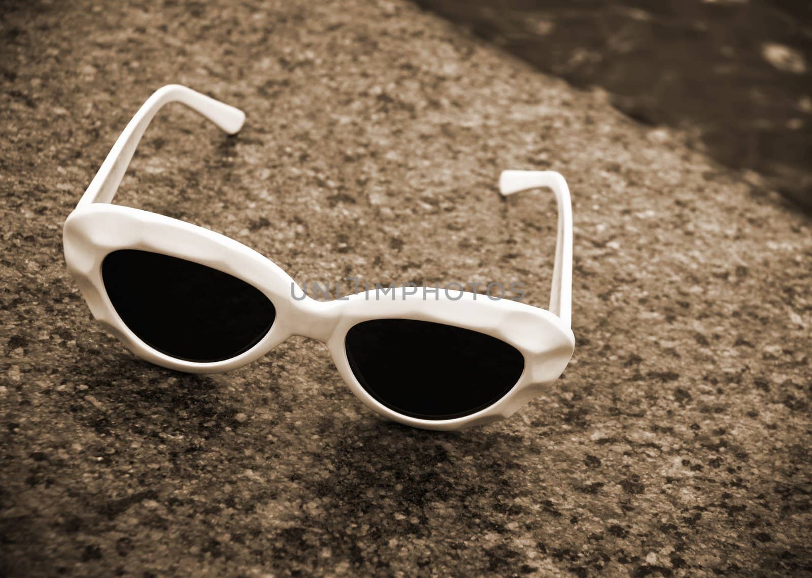 focus point on the sunglasses,special sepia photo f/x with dark vignetting