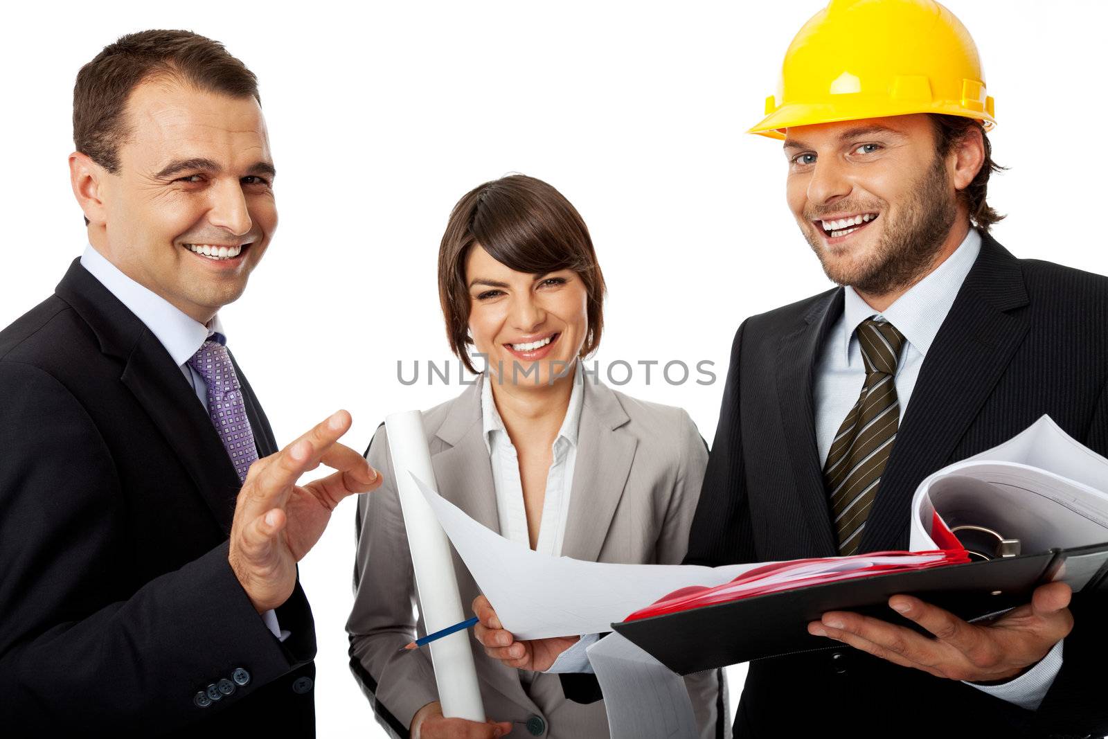 happy three people wearing suits, one with helmet holding plans, isolated on white