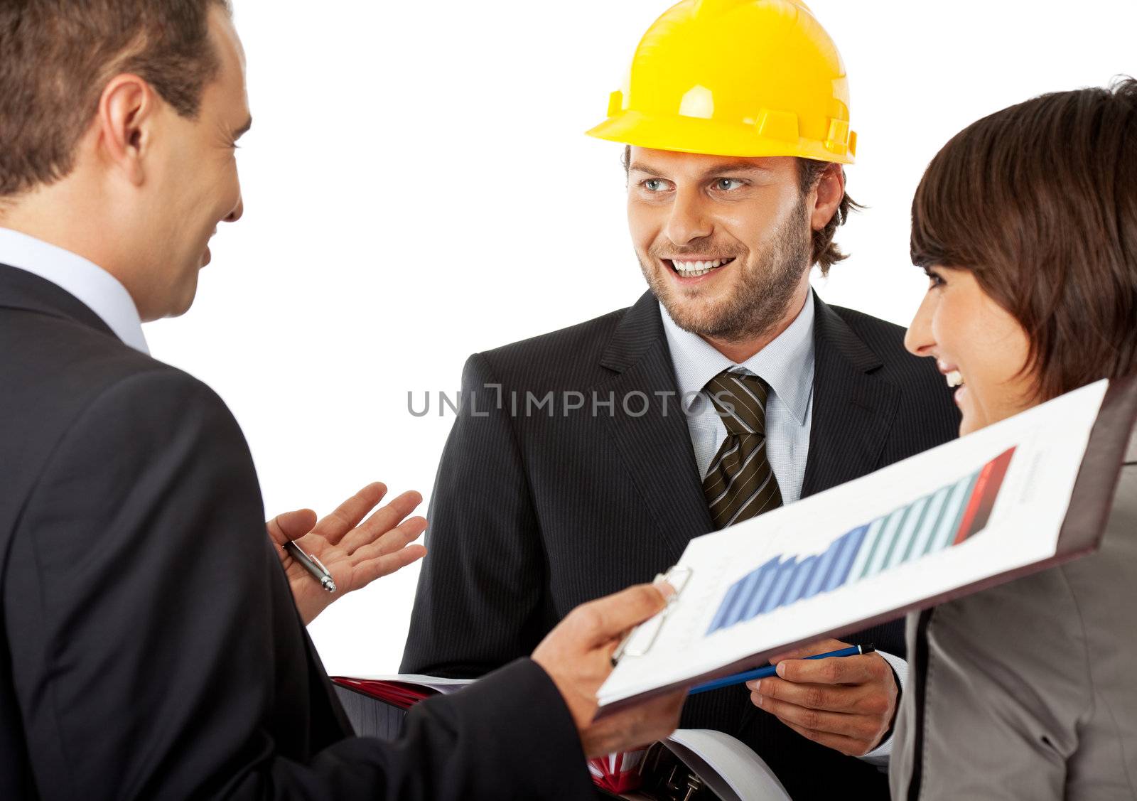 group of three wearing suits, one with a helmet, all smiling