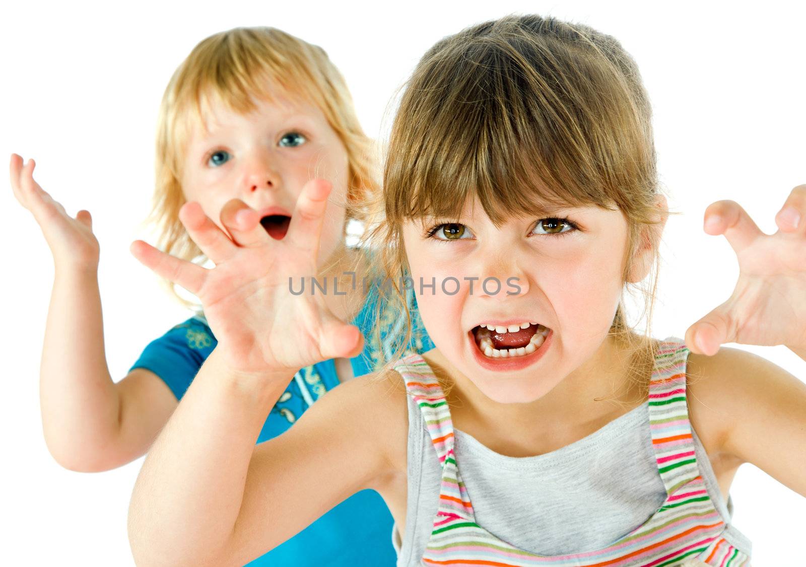 Portrait of two little kids playing, making scary grimaces isolated on white