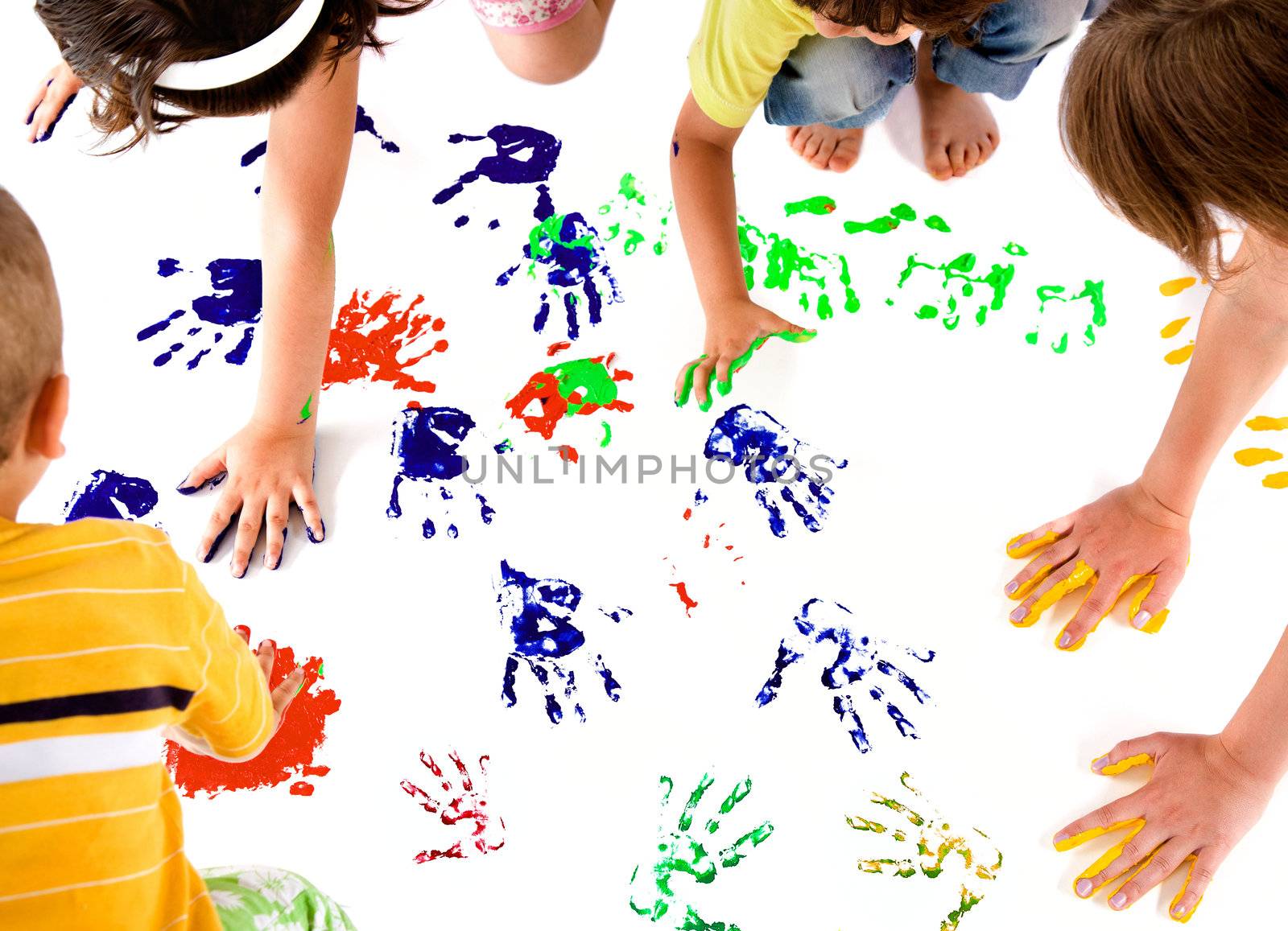 kids making colourful hand prints on white copy space
