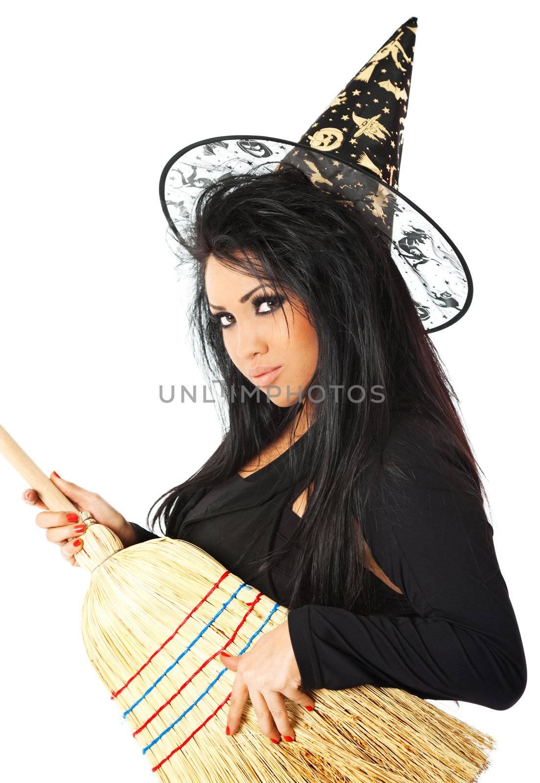 hispanic female in witch costume holding a broom